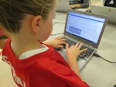 Girl typing on a laptop